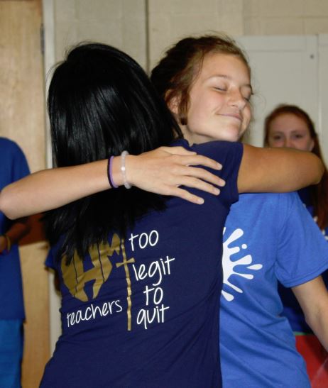 A photo of two girls hugging each other