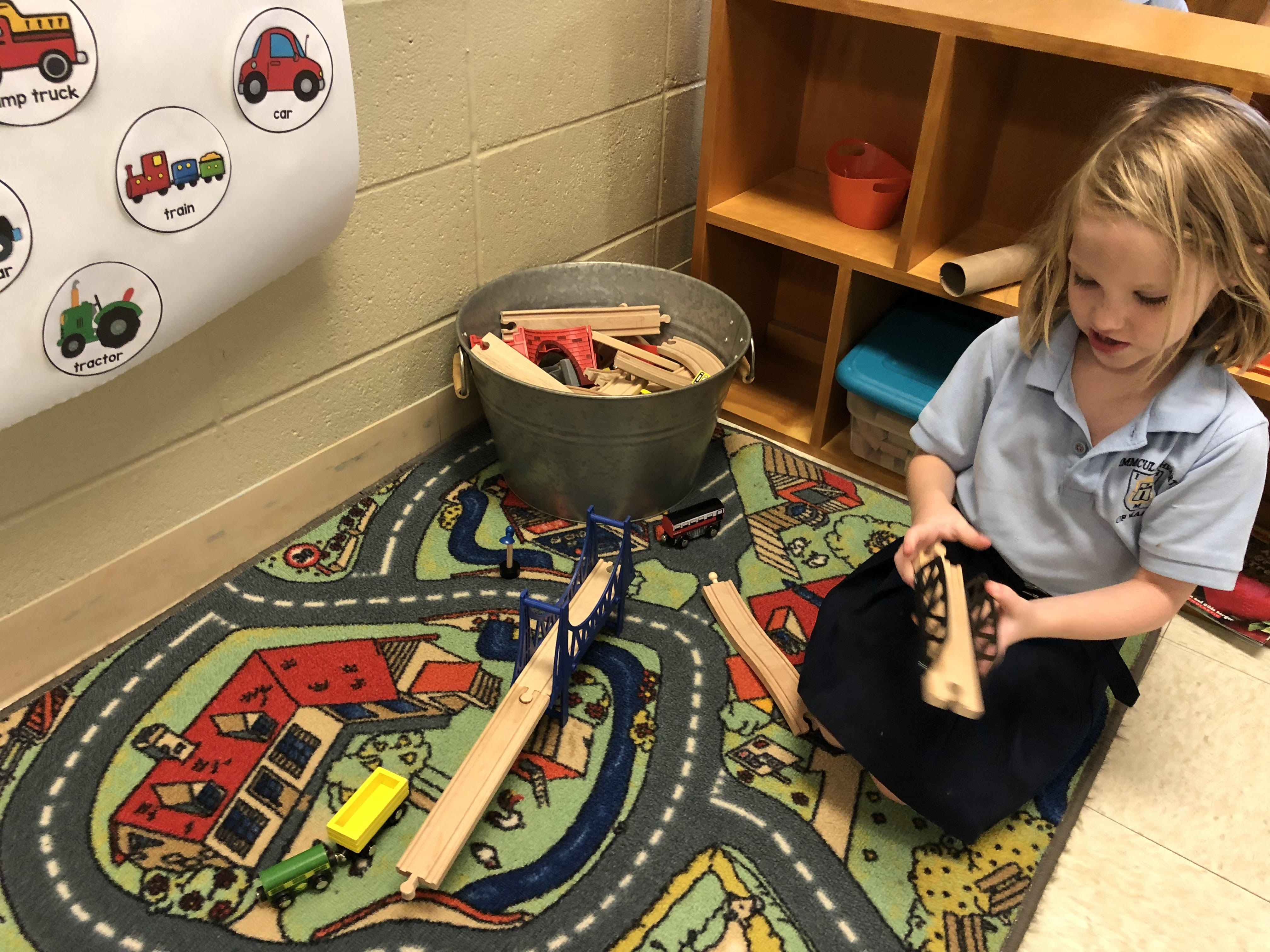 Photo of a girl playing with a construction set