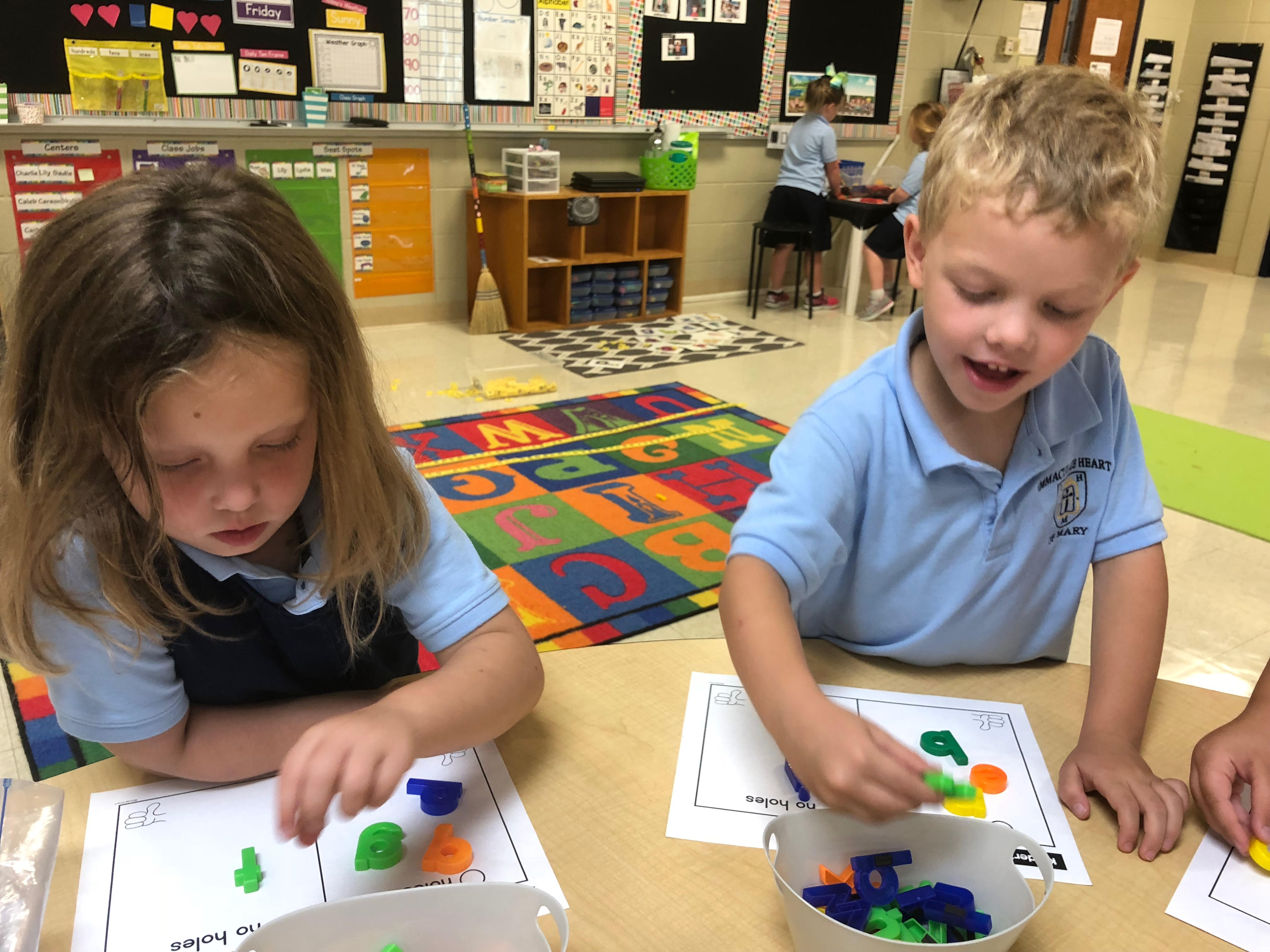 Kids playing with magnetic letters