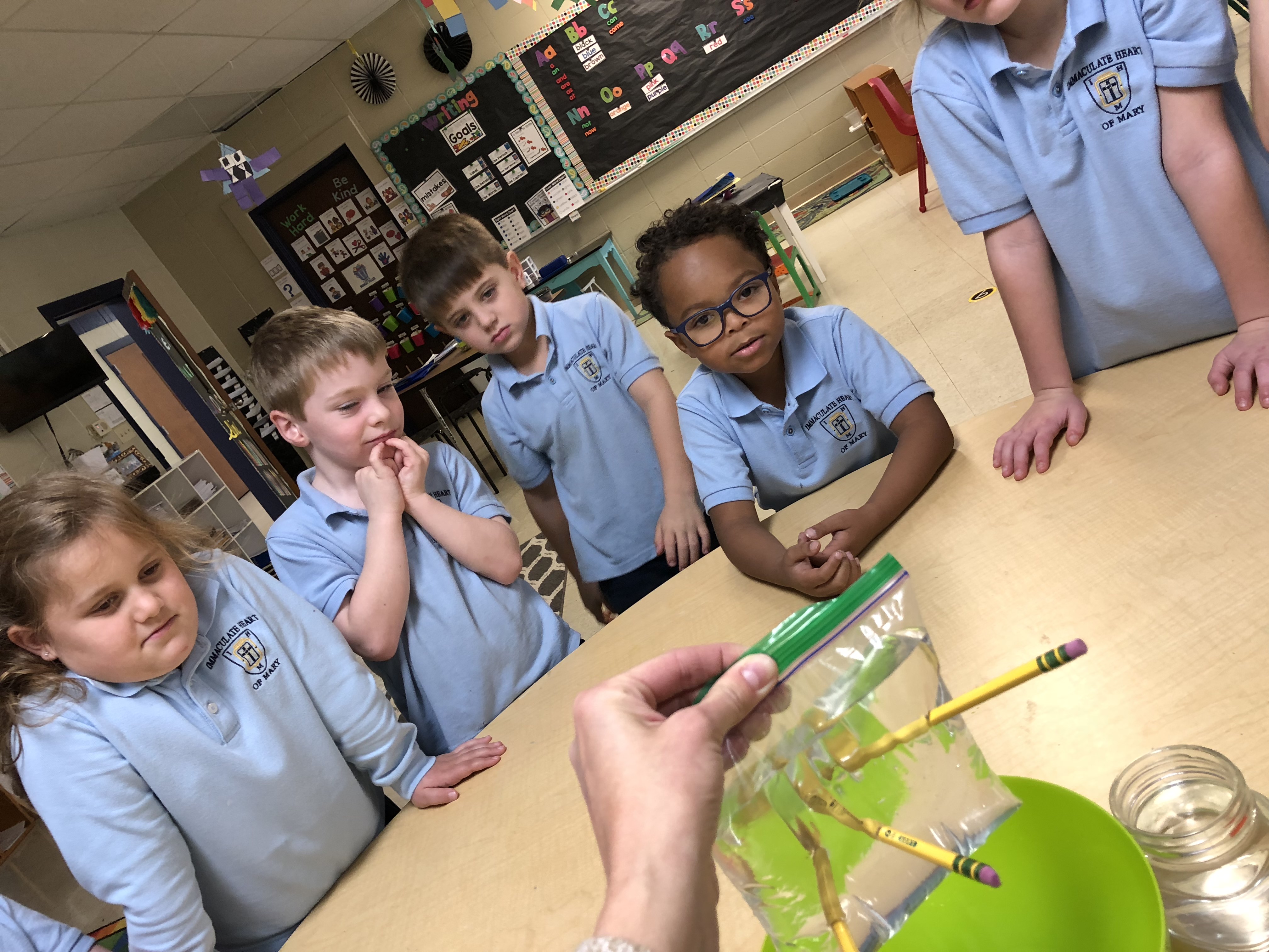 Kids doing an experiment with their teacher