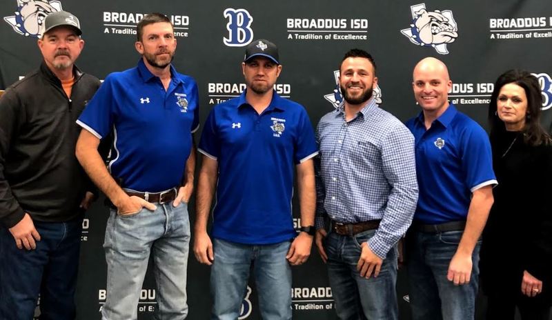 Five school board members pose in front of Broaddus ISD background