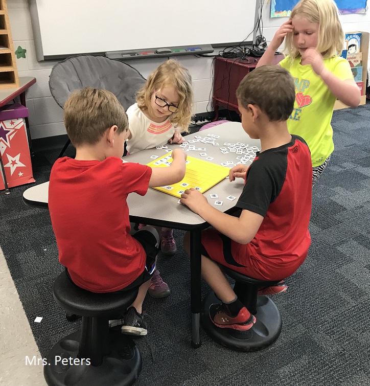 A group of children working in teams for the classwork.