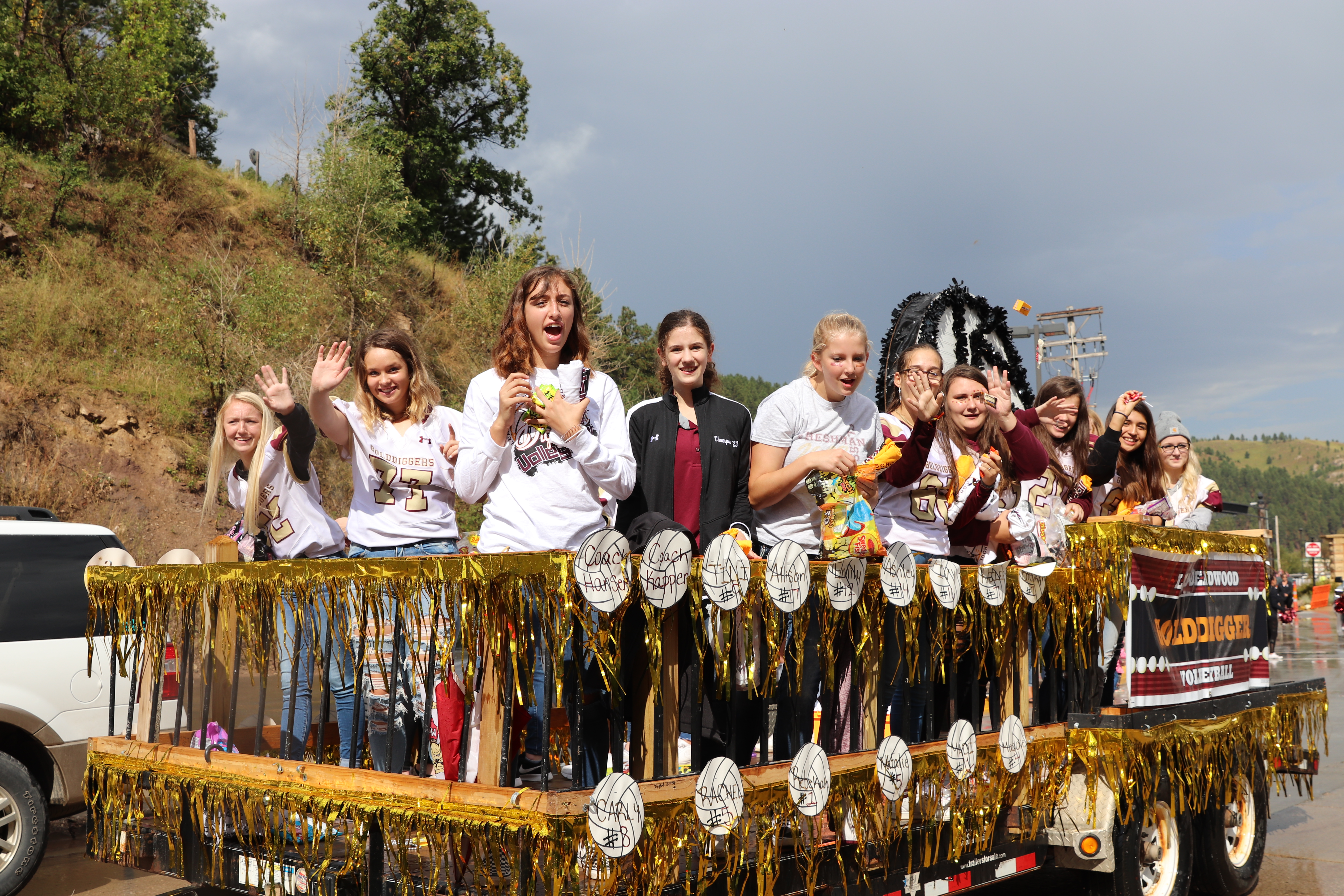 A photo of the girls Volleyball team in a parade.