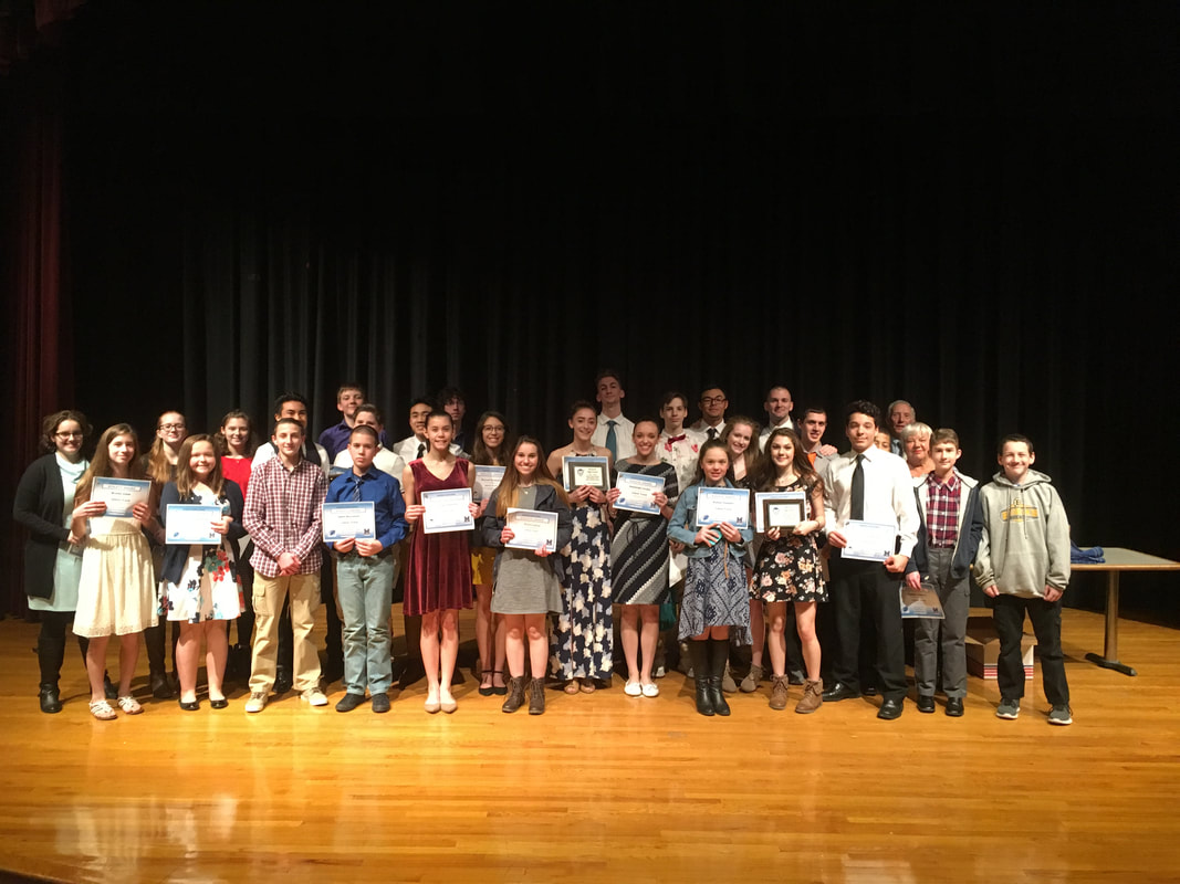 students holding awards