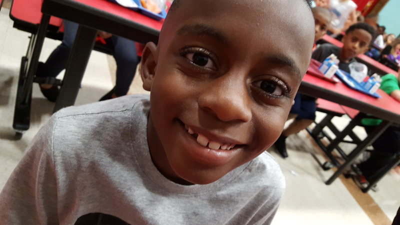 One of the students smiling at the camera