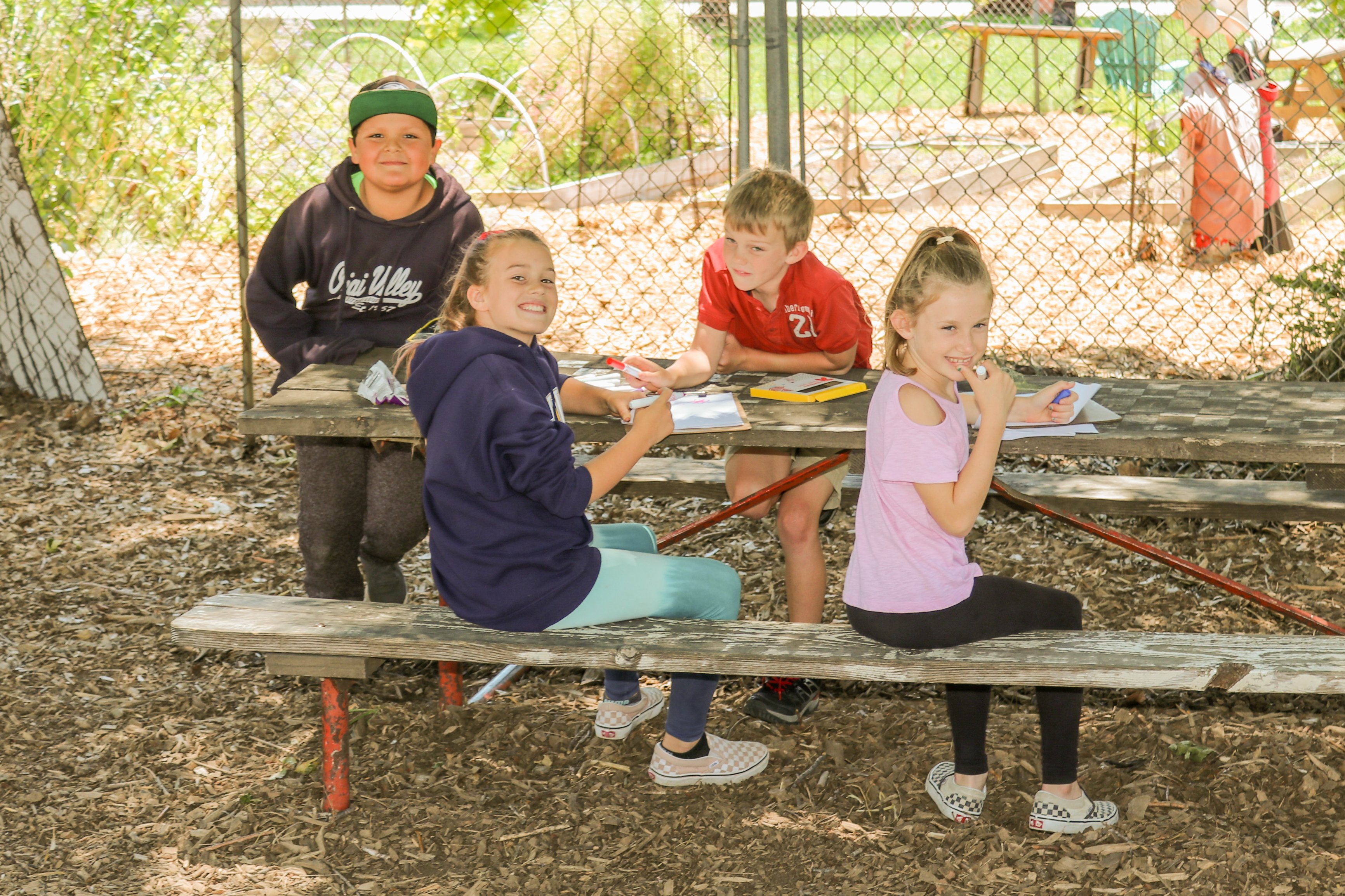 A group of kids all eating and talking together