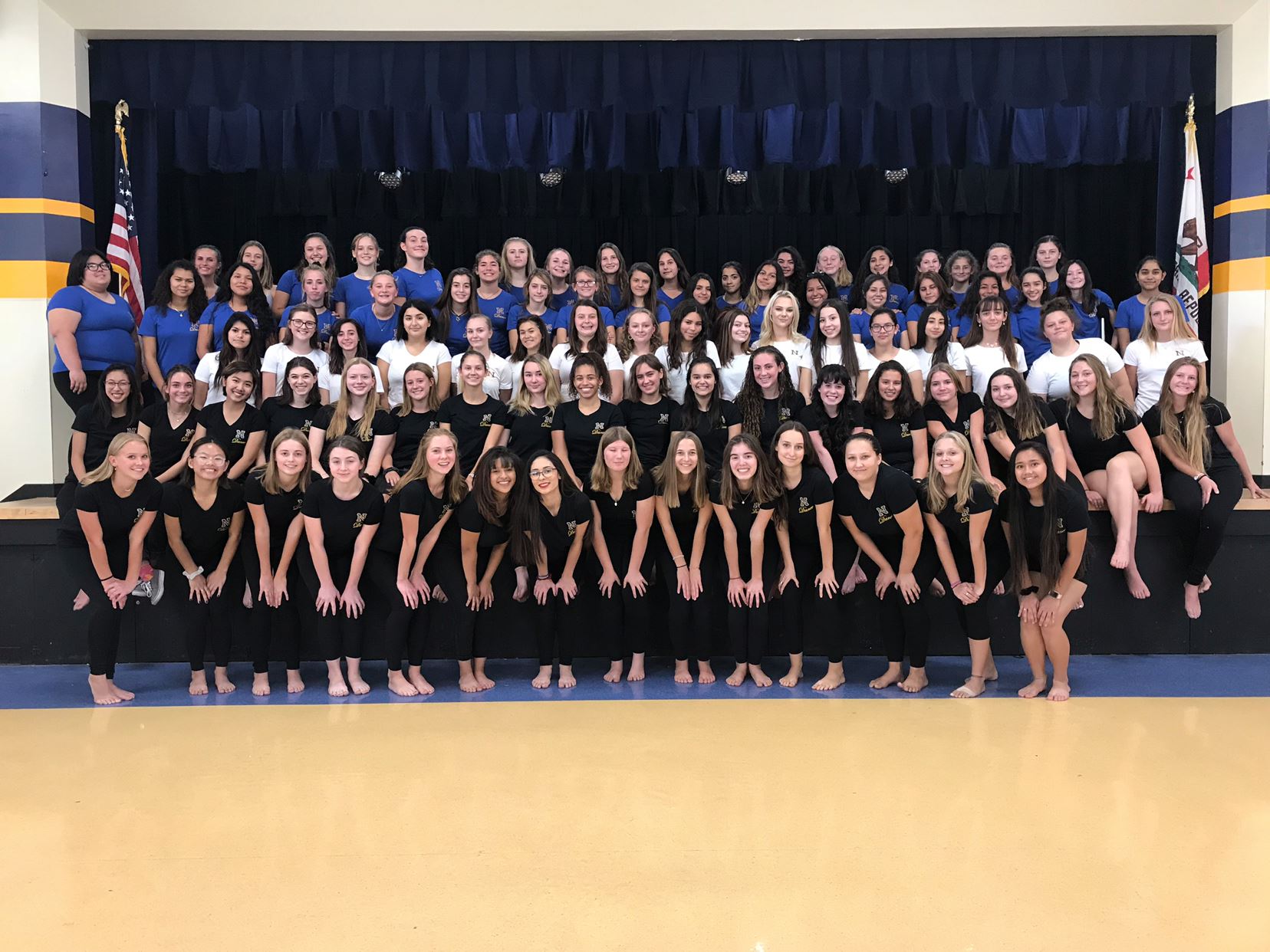 A group with all of the dance member teams in the school's theatre