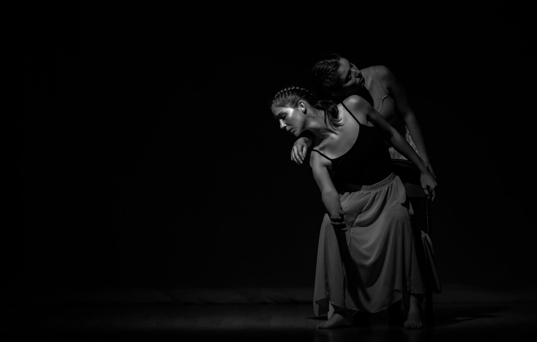 A monochromatic photo with two dancers performing