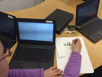A photo of a student working on a project on their laptop