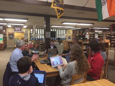 A photo of students working on their laptops in the library