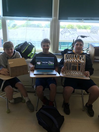 A photo of students showing a project