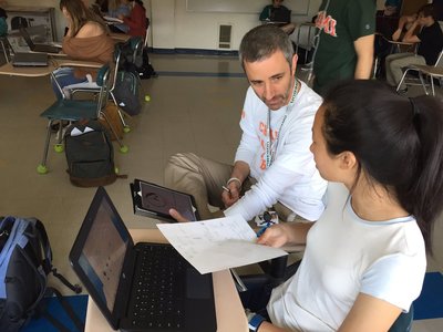 A photo of a teacher helping a student
