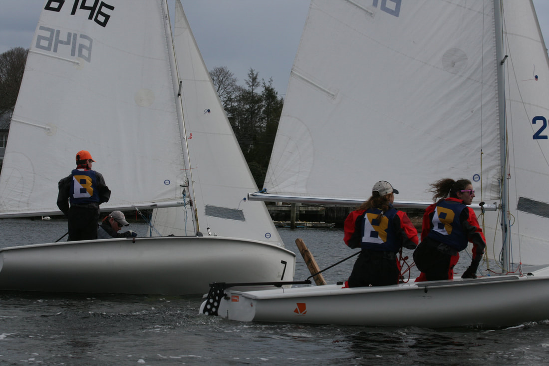 A photo of sailing club members on sailboats