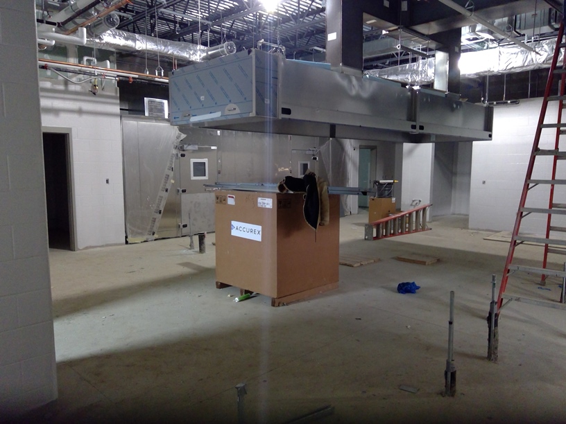 Photo of the Kitchen hood with new freezer and cooler in the background.