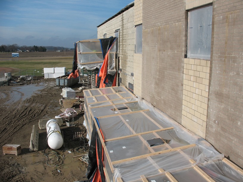 Photo of the Hydraulic scaffolding on the south side of the building under the tent.
