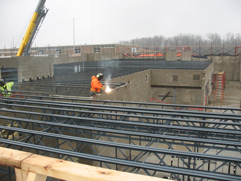 Photo of the Girders being welded to wall plates.