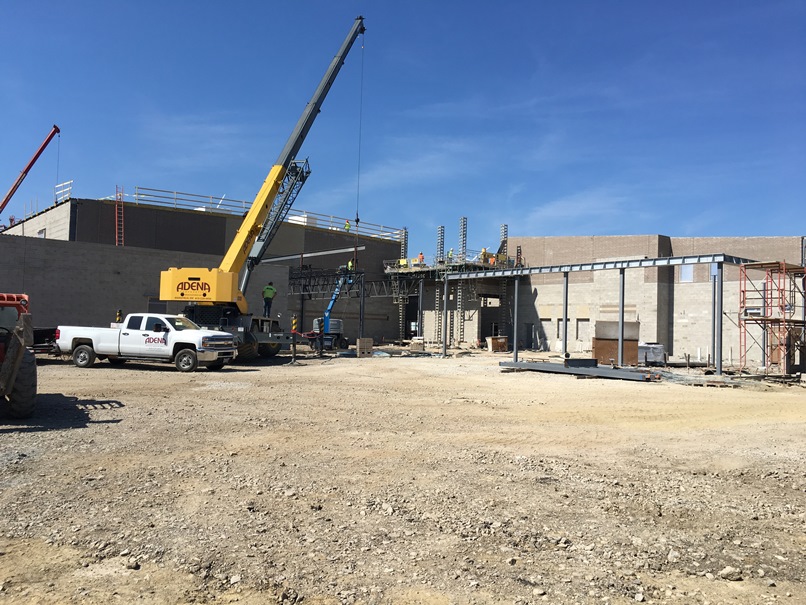 Photo of the crane is setting the girders over the cafeteria.