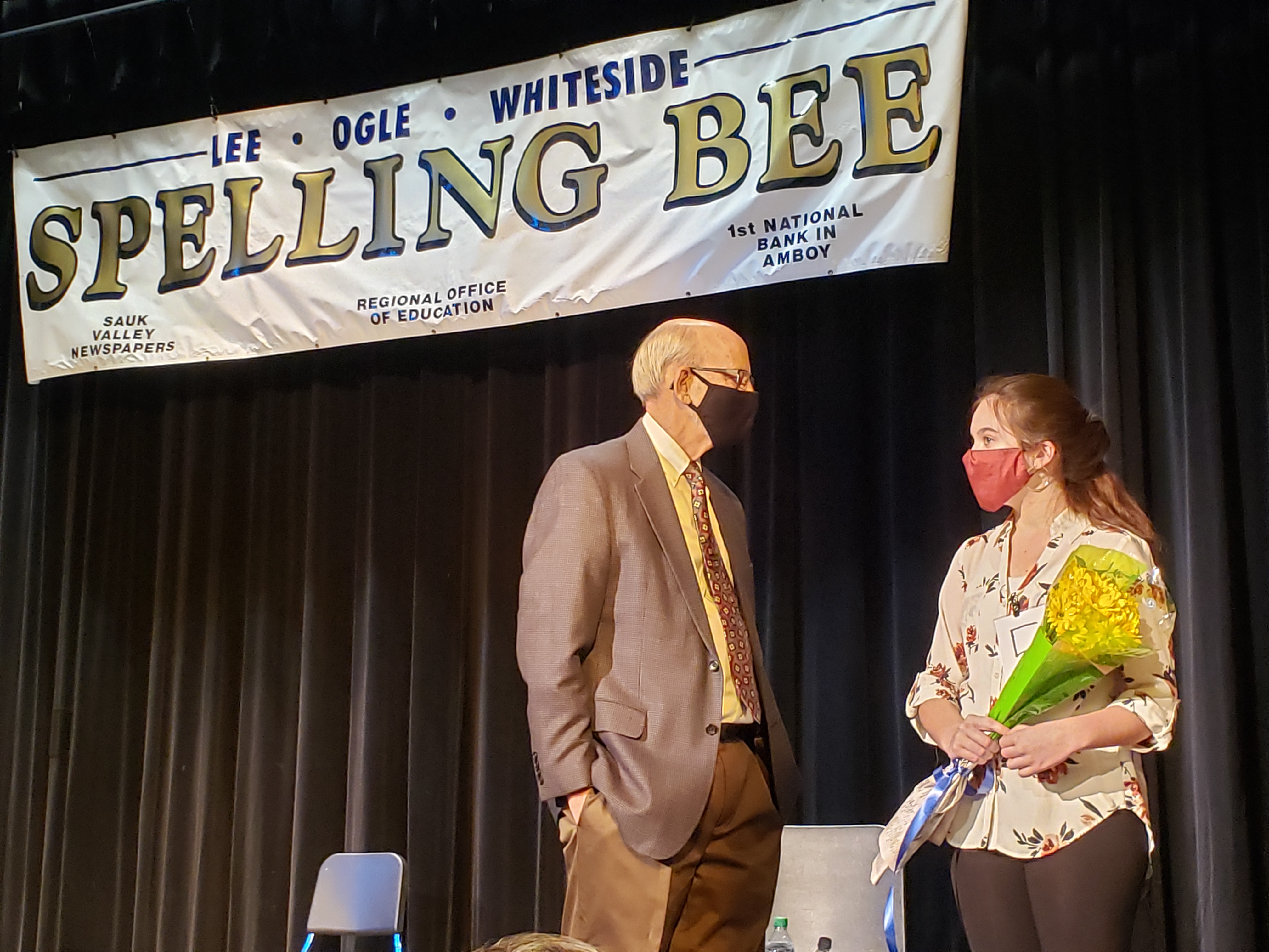 Spelling Bee winner with moderator on stage
