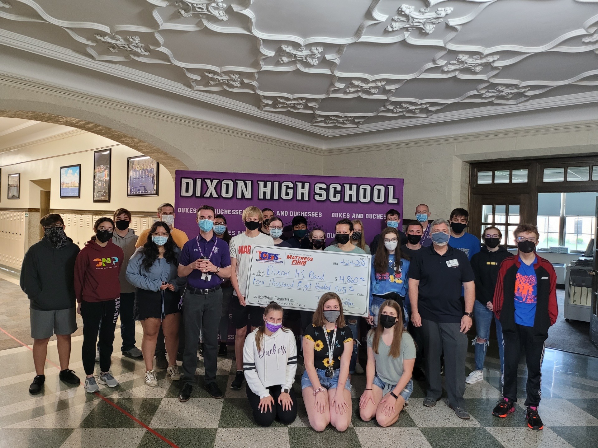 Photo of students and large check presentation
