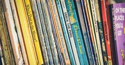 A photo of books all stacked up together
