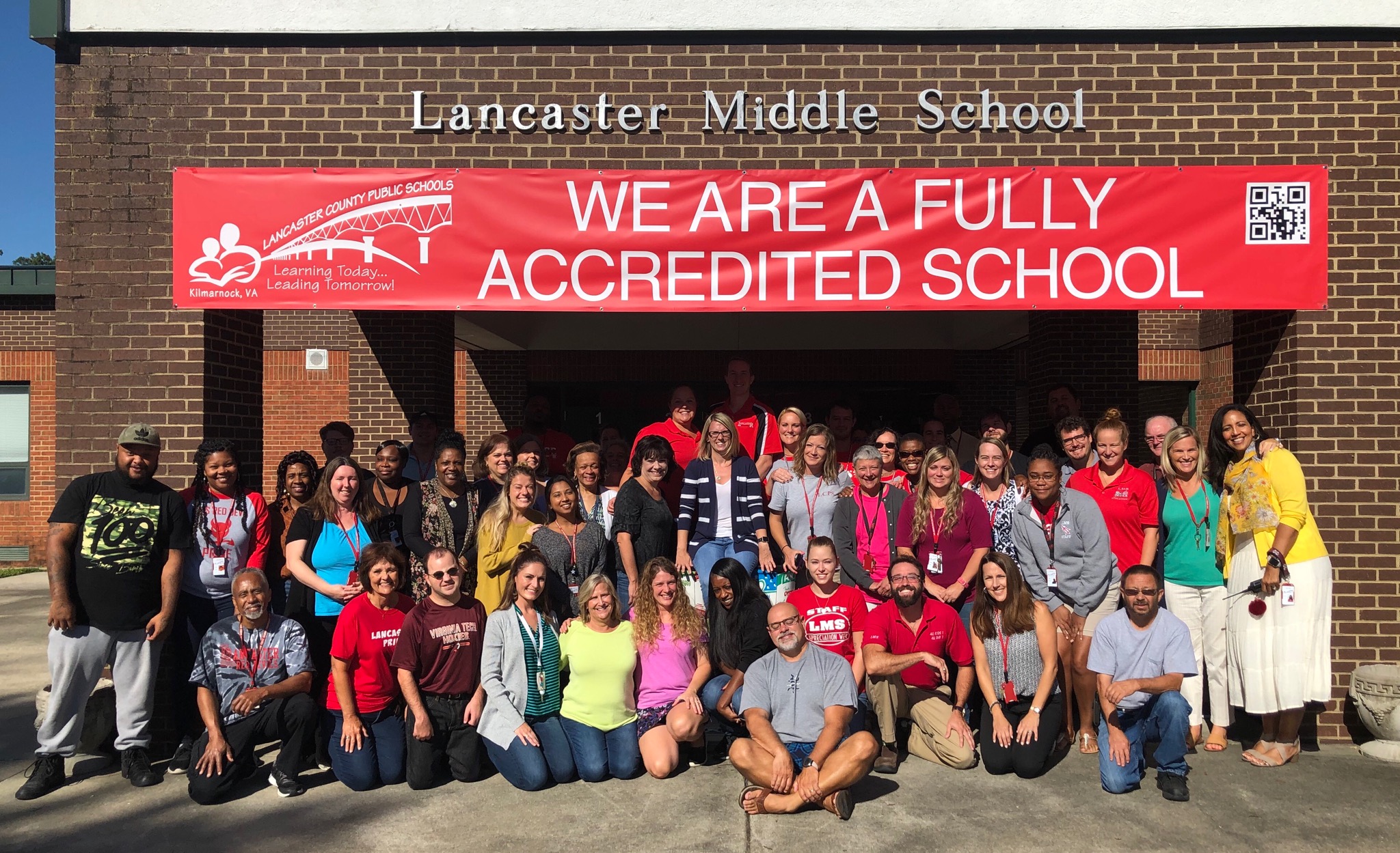 picture of lms staff in front of the building