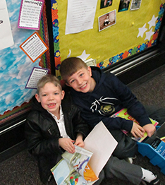 2 boys smiling to the picture
