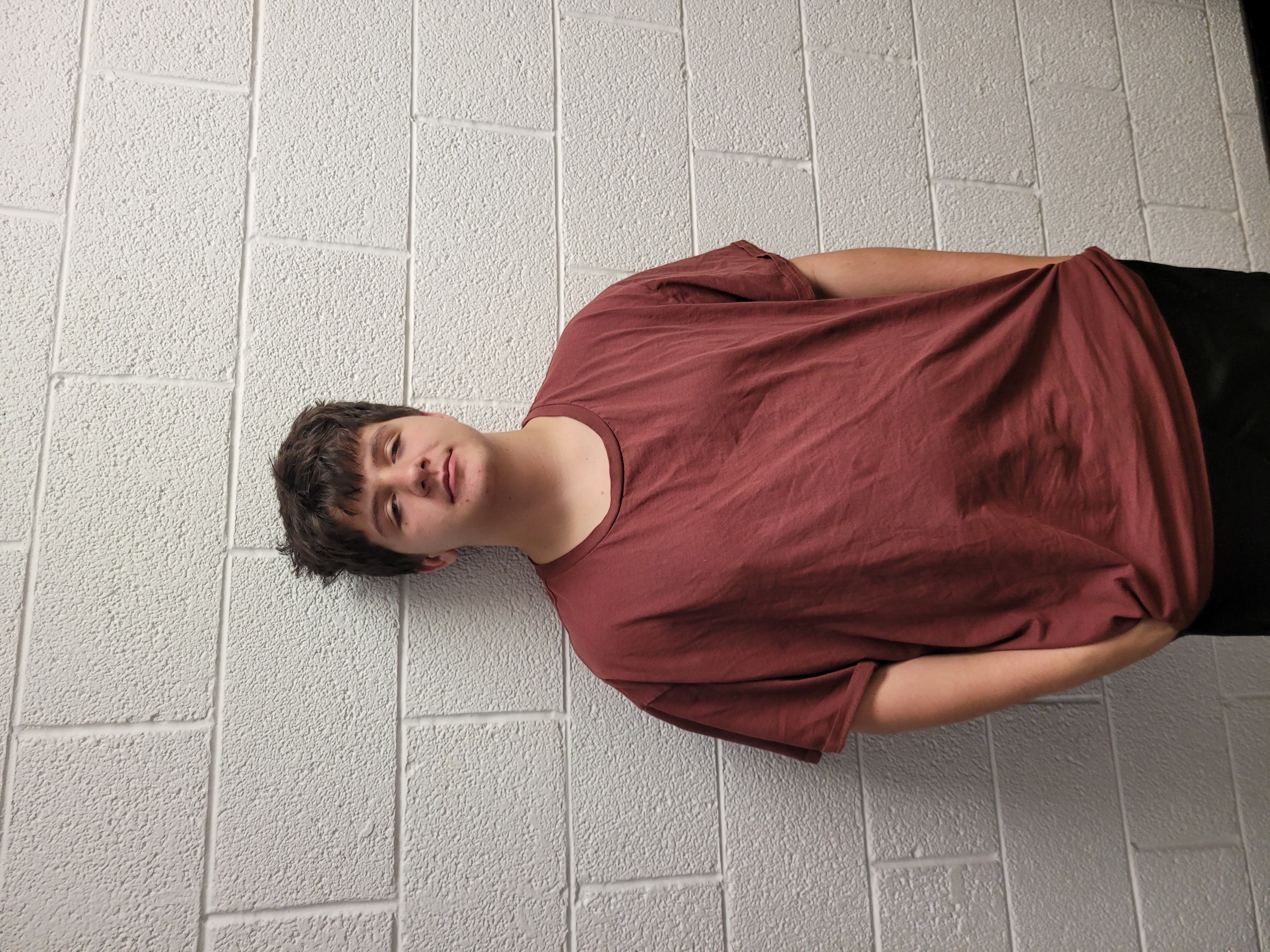Brent Brewer standing against a wall