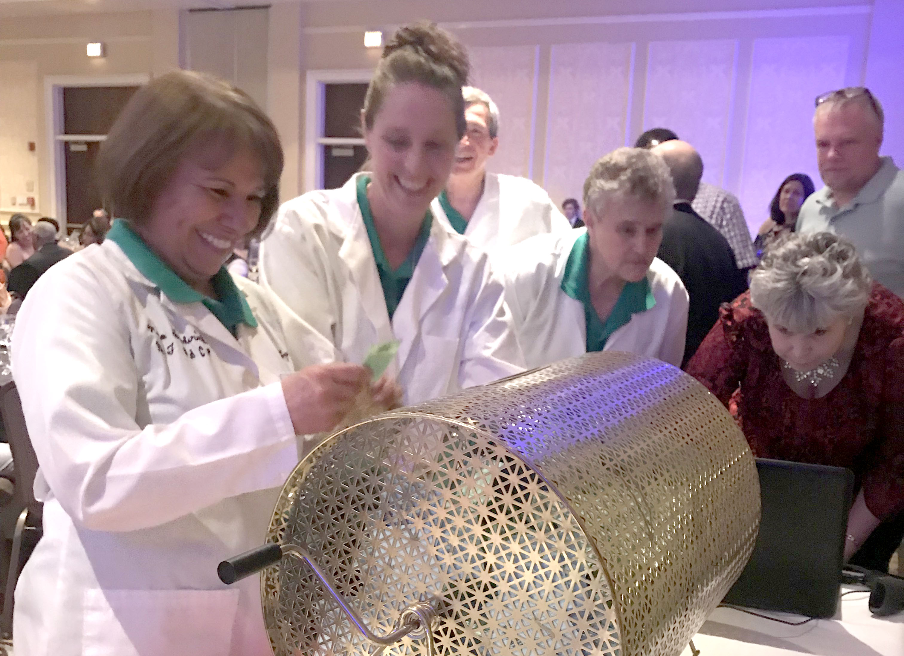 A woman pulling out a raffle ticket