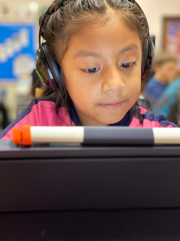 A girl learning through the use of a tablet