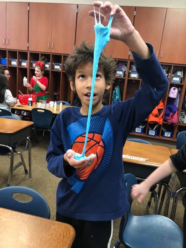 A boy playing with a ball of slime