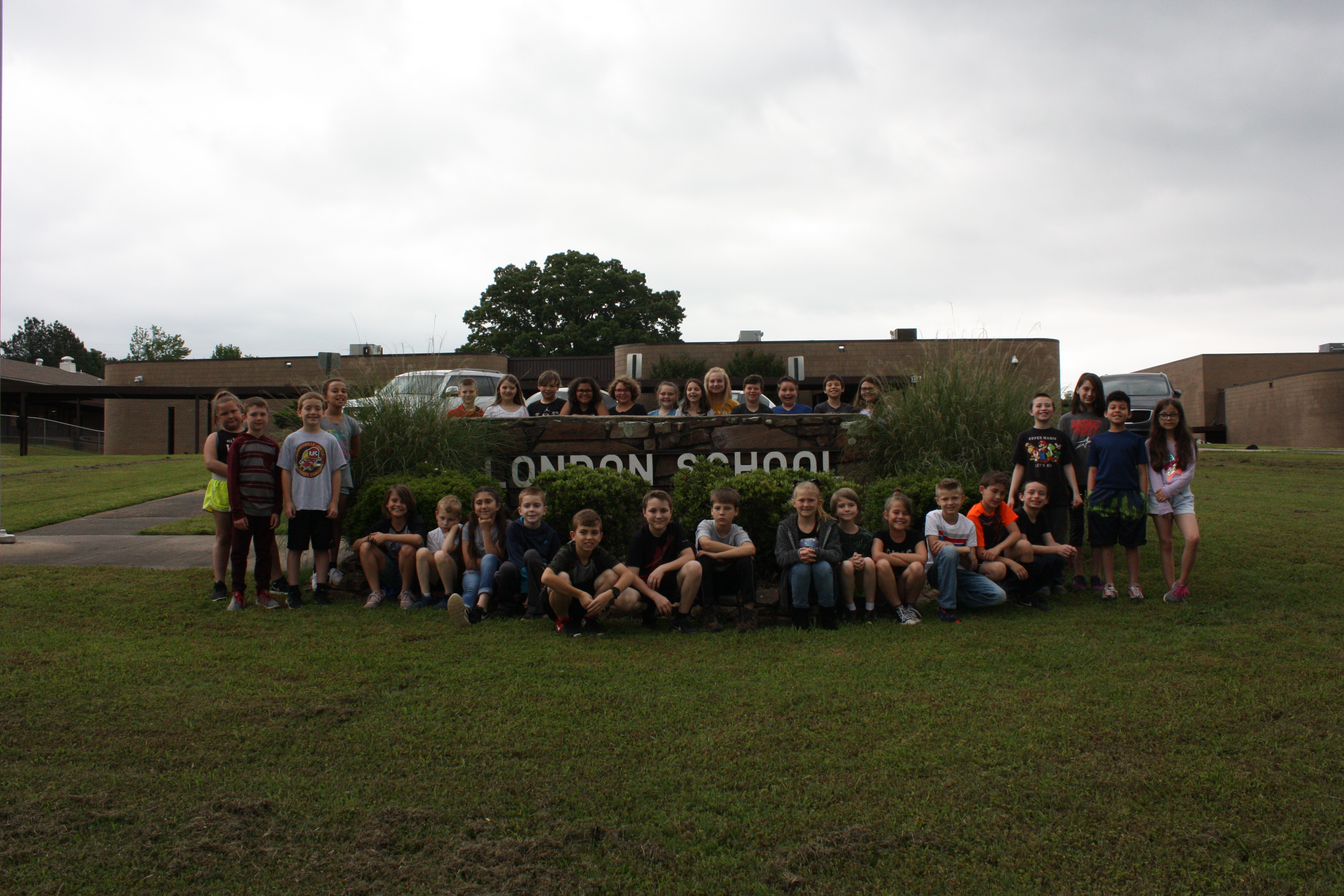 Photo of the students posing outside the school's building