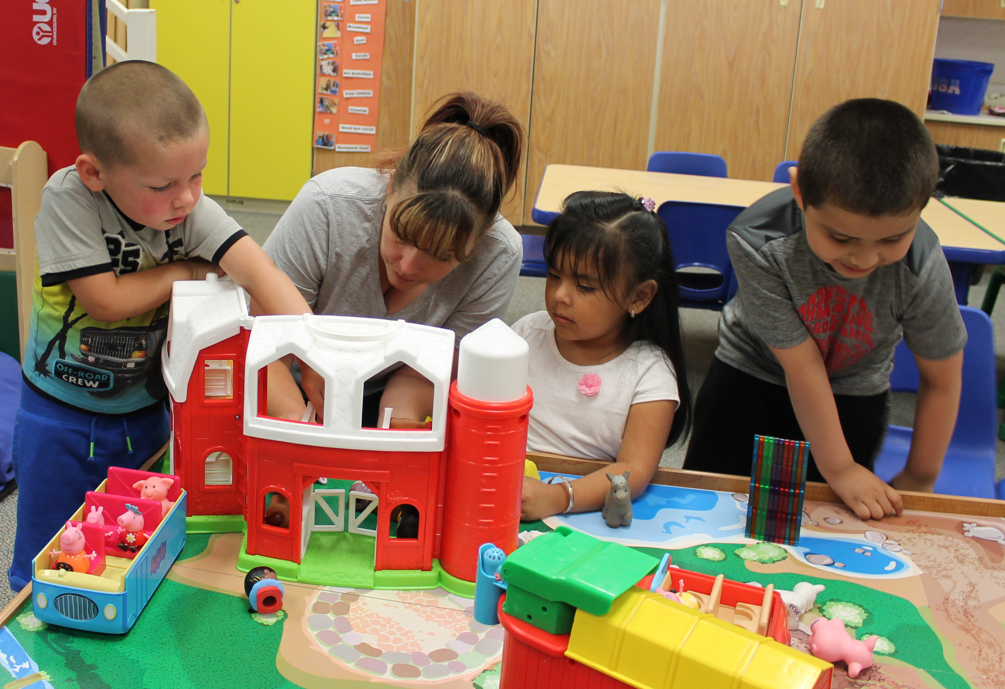 A photo of a teacher playing with some students.