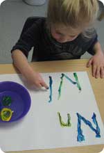 A student playing with paint