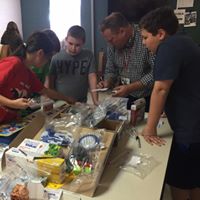 Members gathering around a table