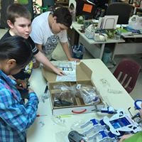 Members checking out stuff in a box