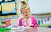 Young girl working in class