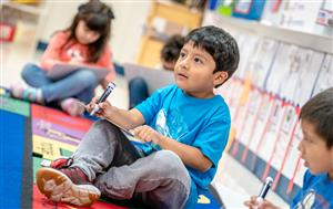 Young boy sitting in class
