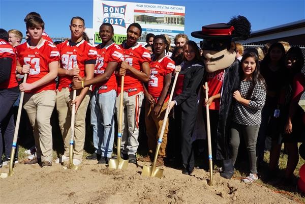 A large group with shovels breaking the first dirt on construction project