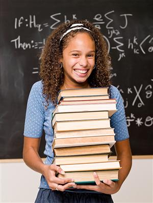 Photo of a student with many books.