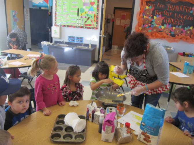 kids making cupcakes in class