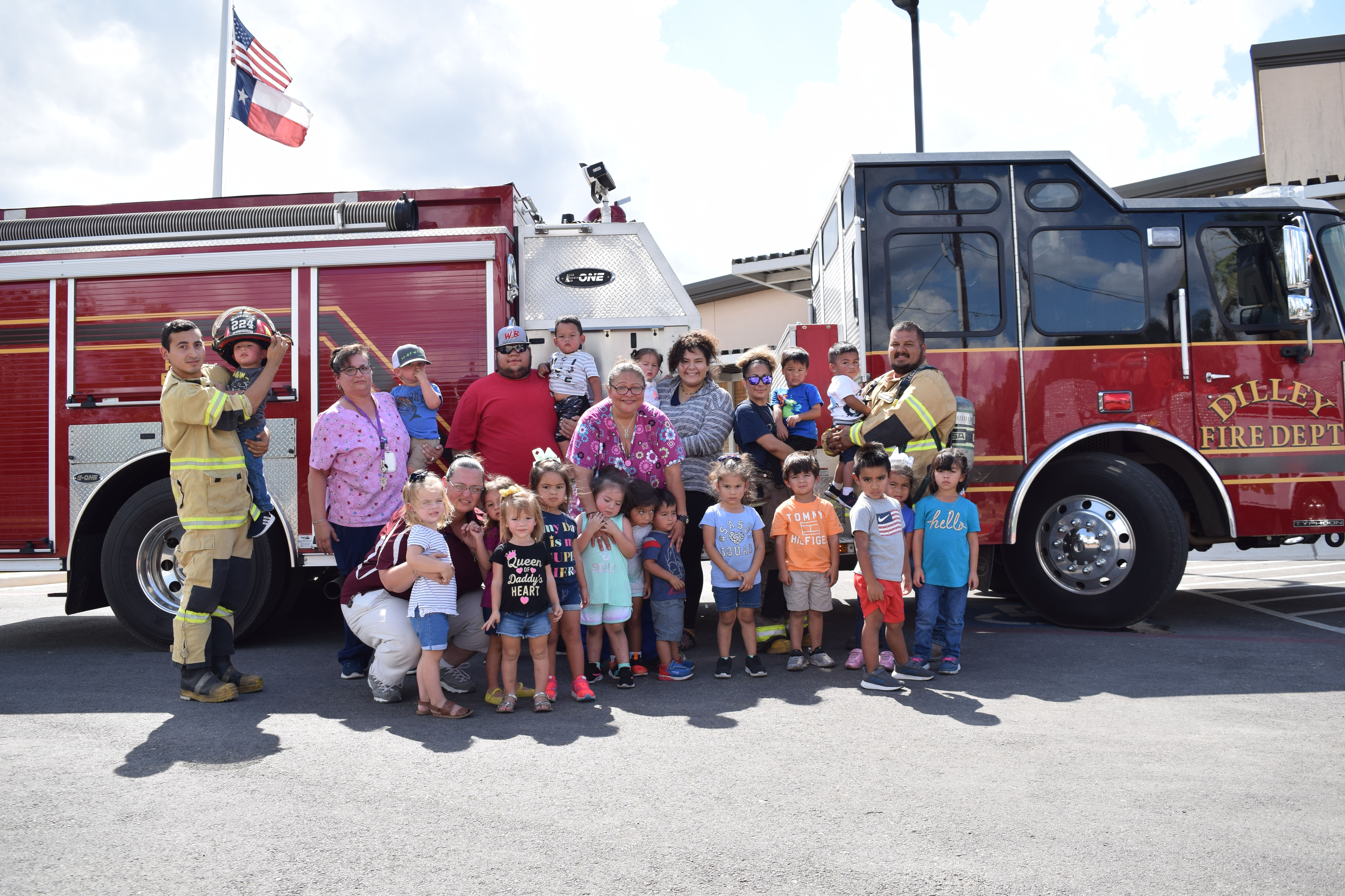photo of staff and children in front of a fire truck