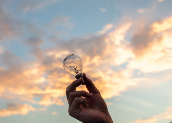 Ideas - person holding a lightbulb