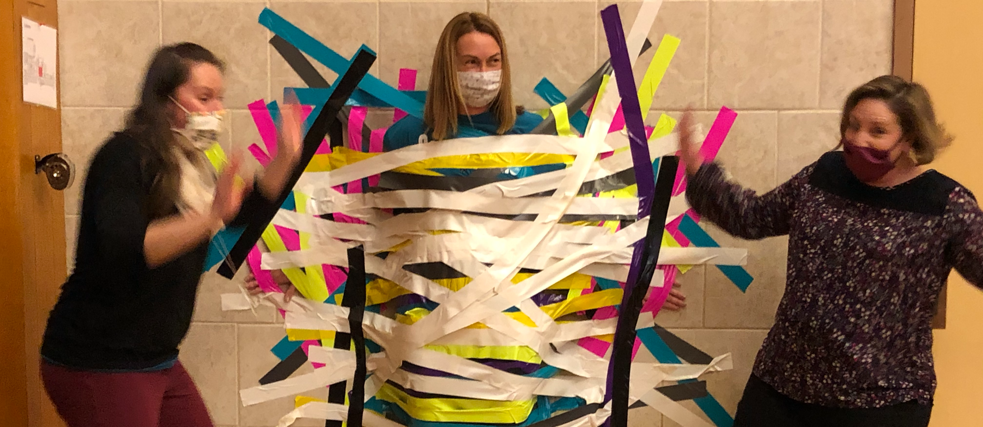 Mrs. Coppolo duct taped to the wall