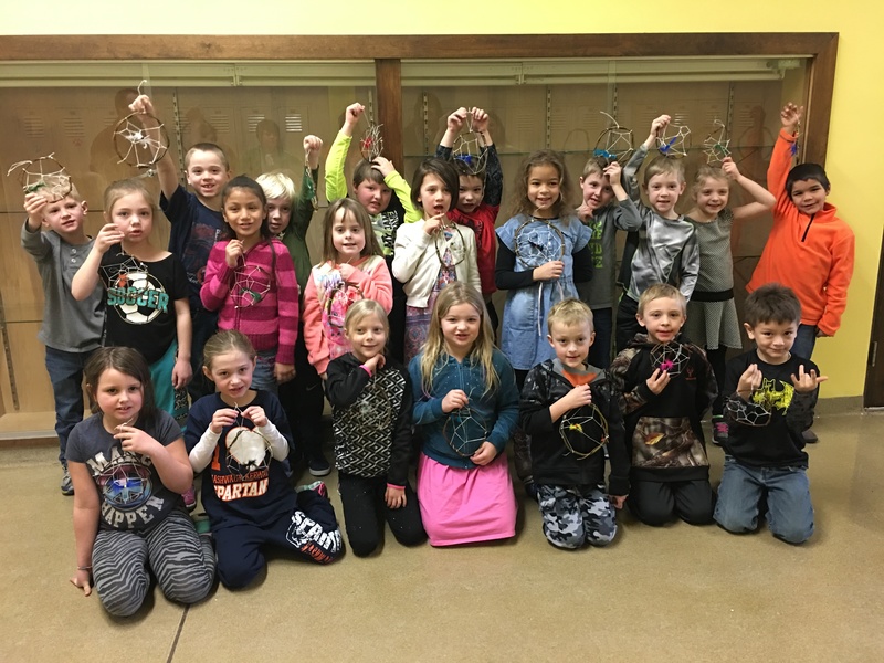 Kids holding up dream catcher