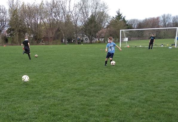 kids in field playing soccer
