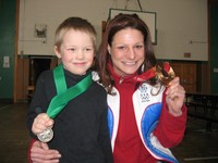 Olympian Kim Insalaco poses with a Student of the Month recipient.