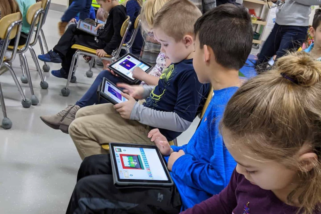Three Students Using Technology Devices