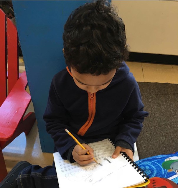 Student Writing in Book