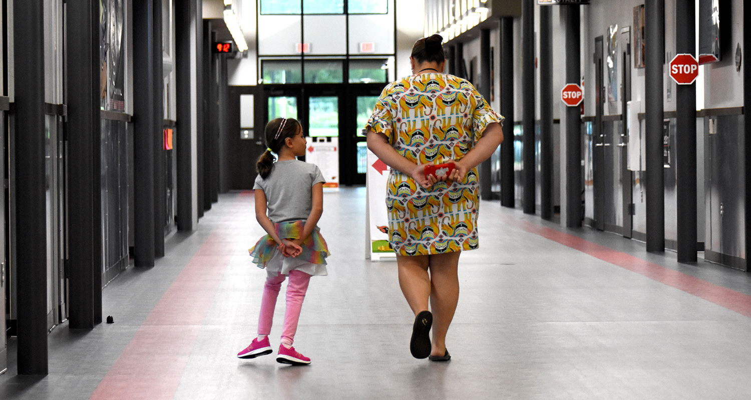Student and teacher walking down the hallway