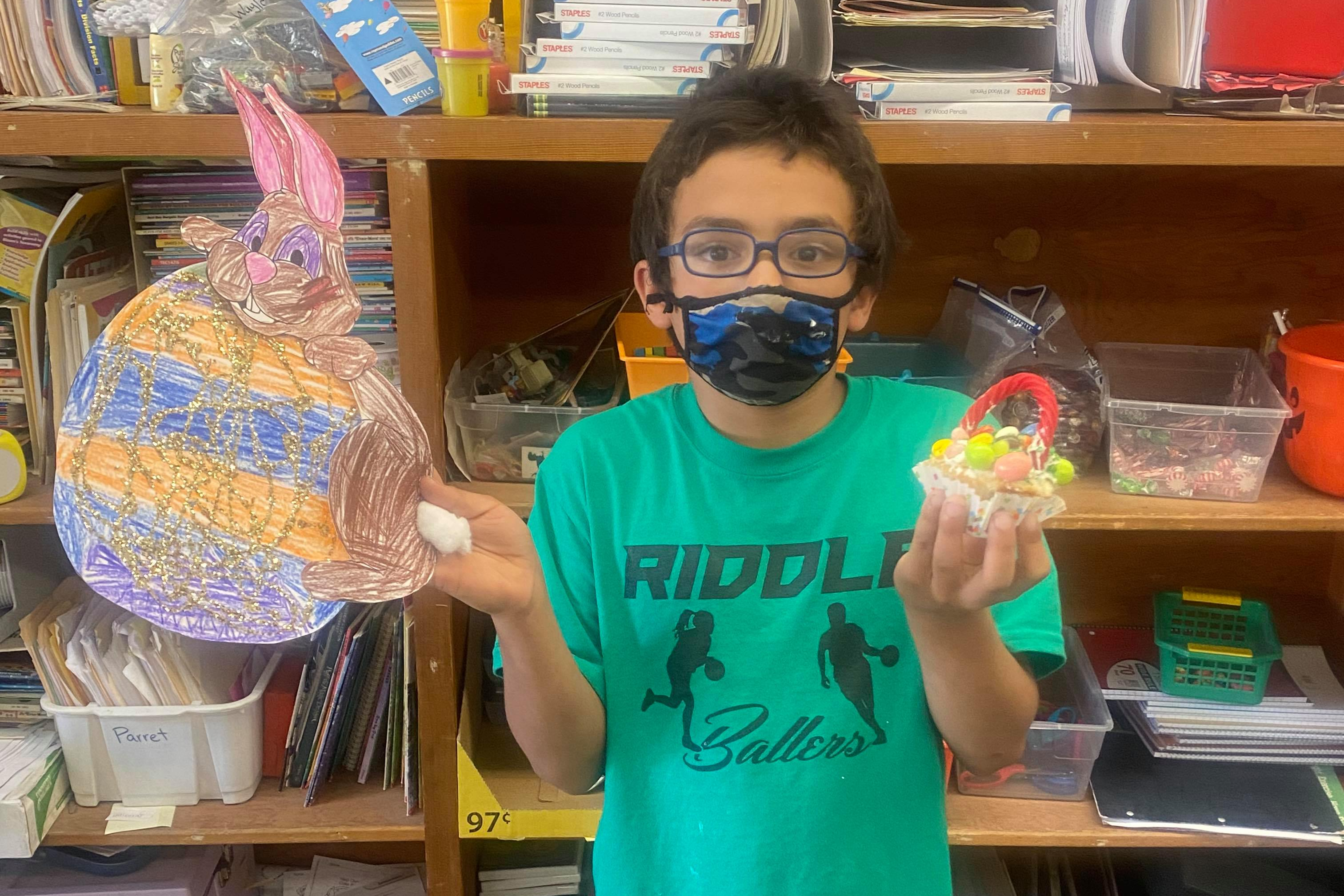 Mrs. Colby's student shows off their Easter artwork.